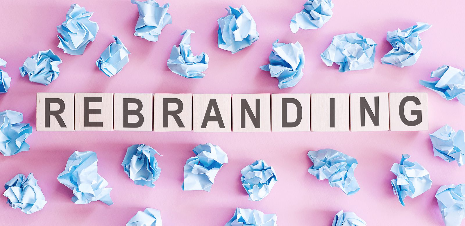 rebranding word written on white blocks on a pink background
