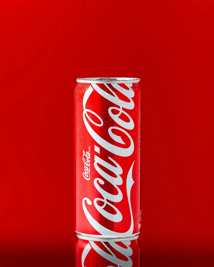 The Coca-cola logo is a famous example of the wordmark logo. It invokes feelings of nostalgia, happiness, and refreshing enjoyment. Image source: Mae Mu on Unsplash